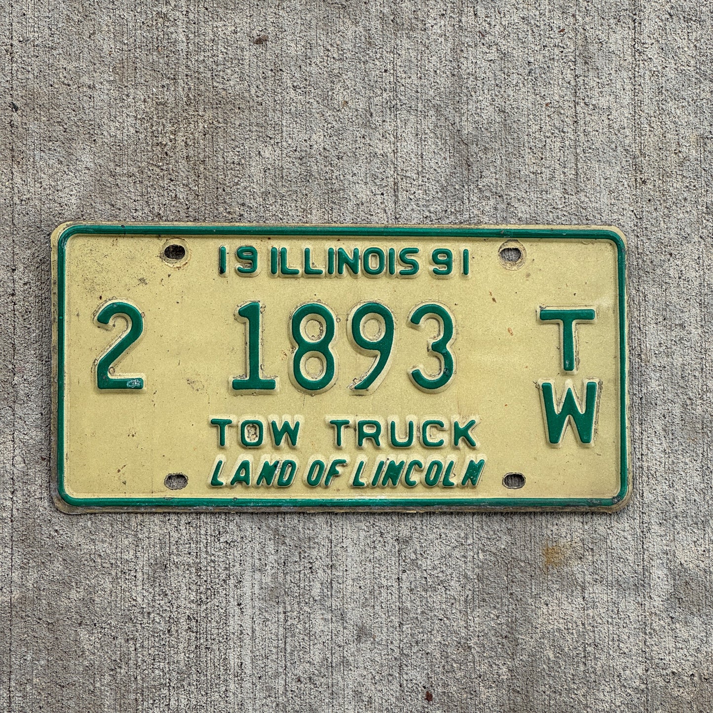 Photo of a 1991 Illinois Tow truck License Plate Auto Tag 1 Vintage Garage 2 1893 TW with original patina