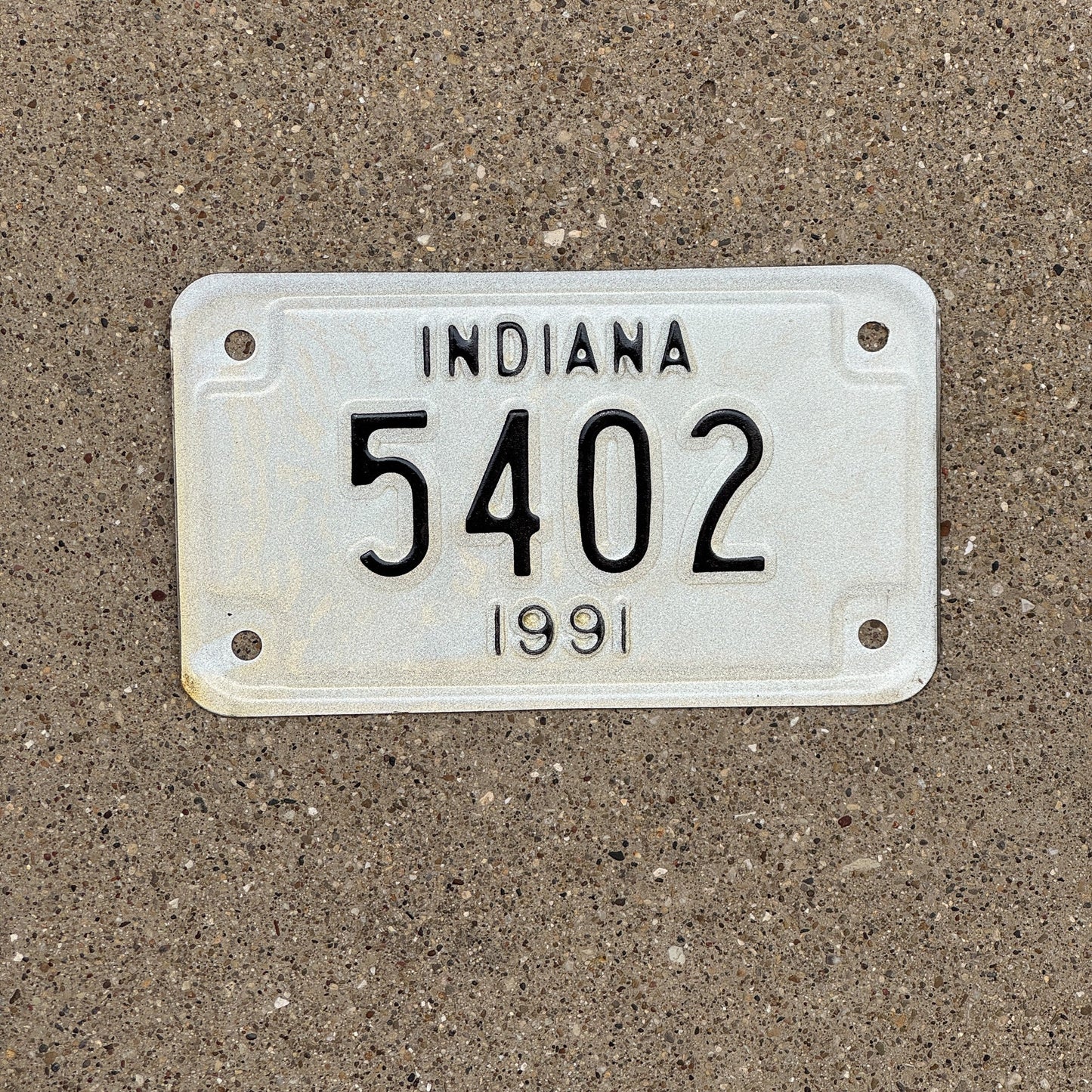 Photo of a 1991 Indiana Motorcycle License Plate Auto Tag Garage Decor Vintage Four Digit 5402