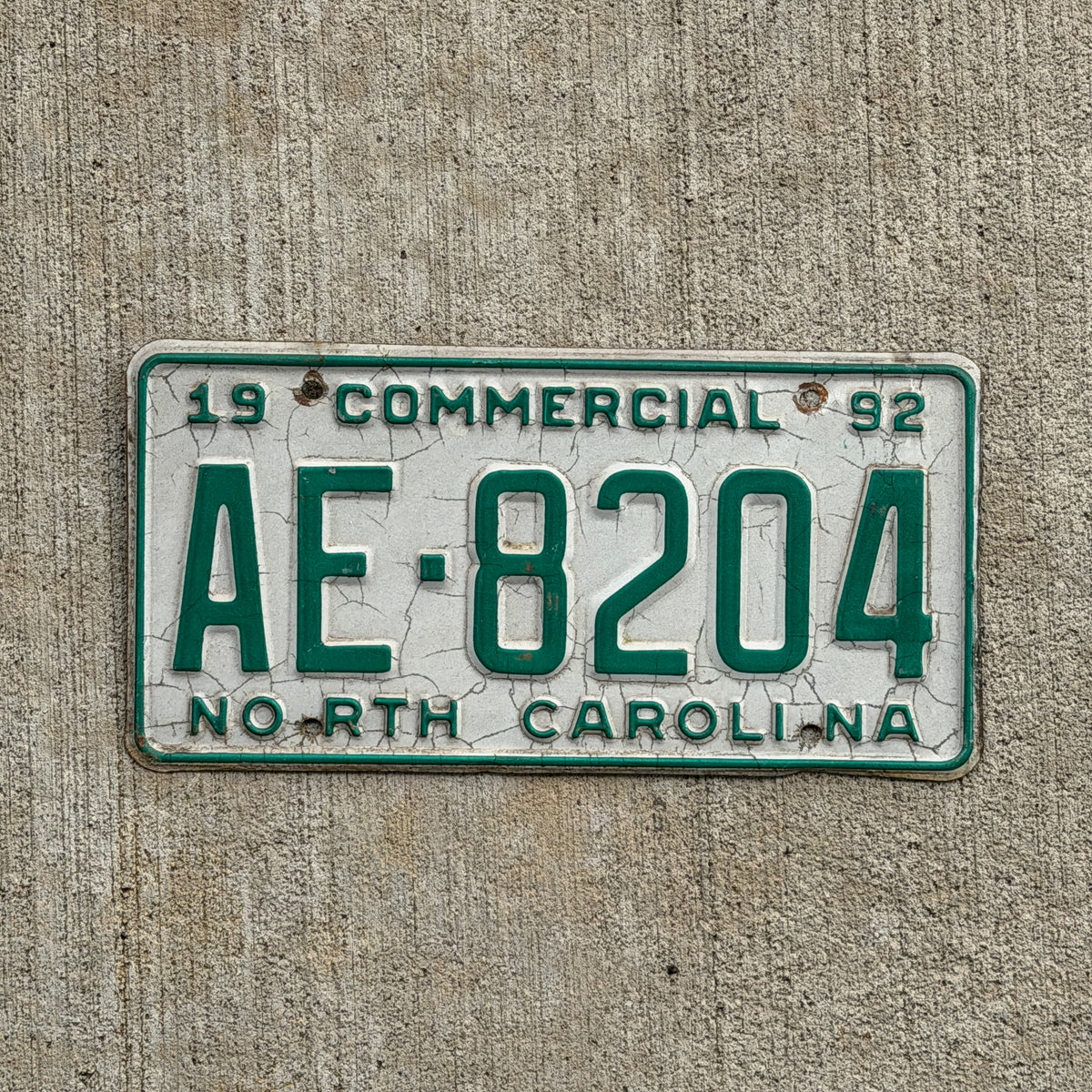 Photo of a 1992 North Carolina Commercial License Plate Auto Tag Garage Decor Vintage AE 8204 with original patina