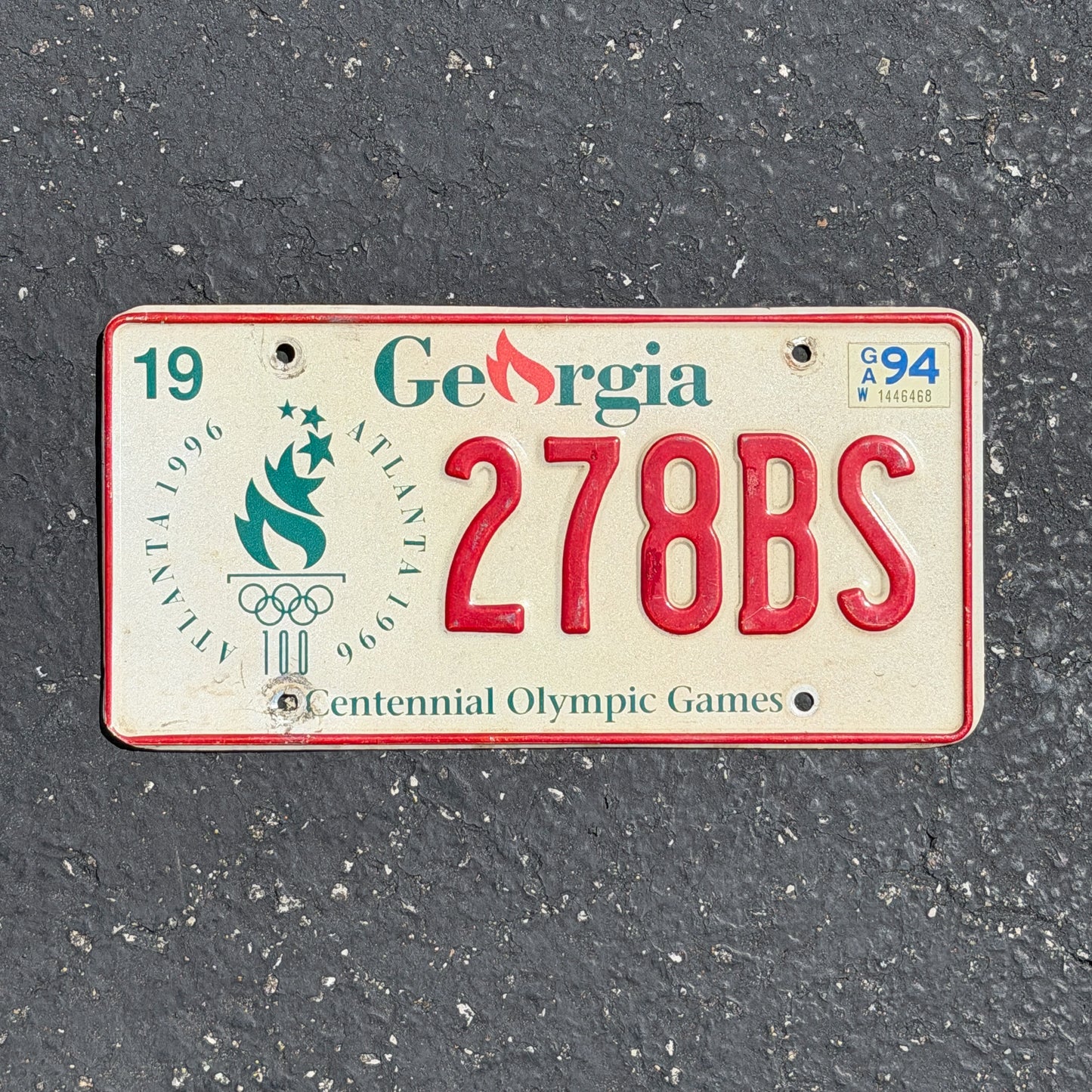 Photo of a 1993 1996 Georgia Graphic / Specialty License Plate Auto Tag Garage Decor Vintage Atlanta Olympic Games Sports 278 BS with original patina