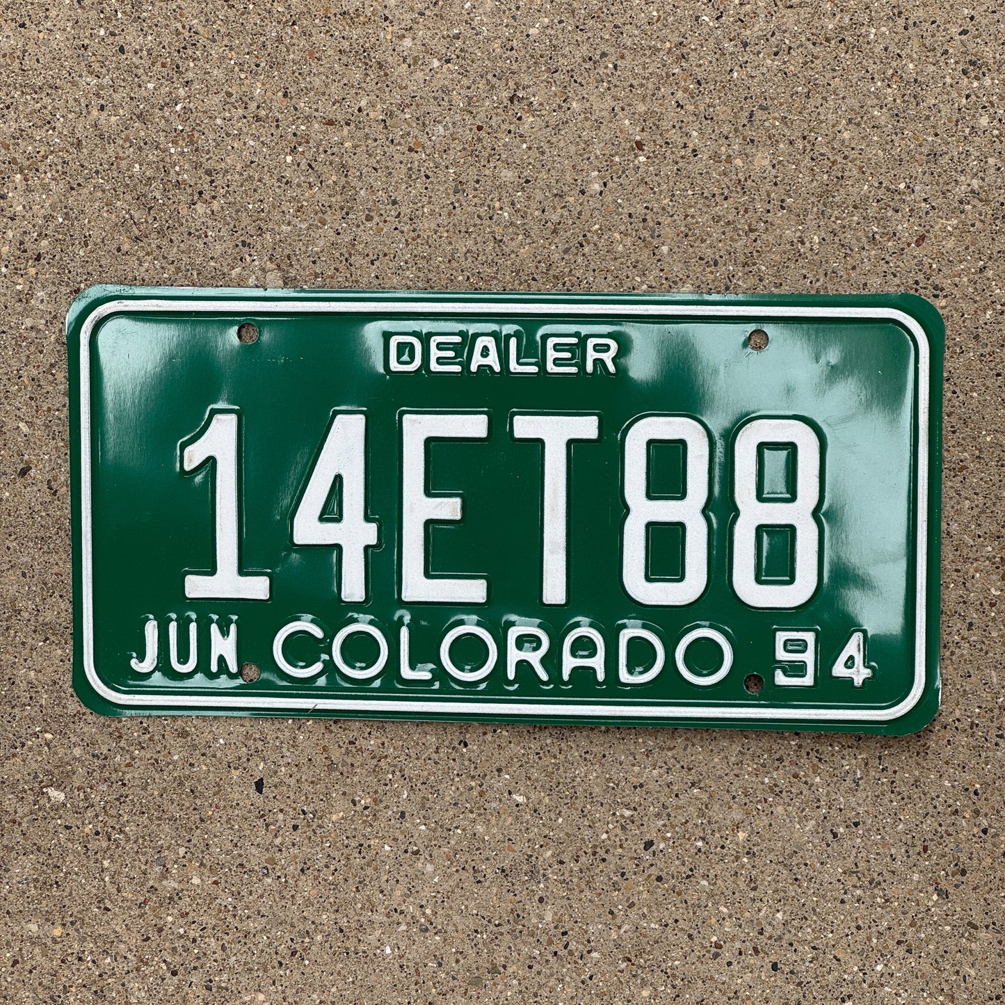 Photo of a 1994 Colorado Dealer License Plate Auto Tag Garage Decor Vintage 14 ET 88