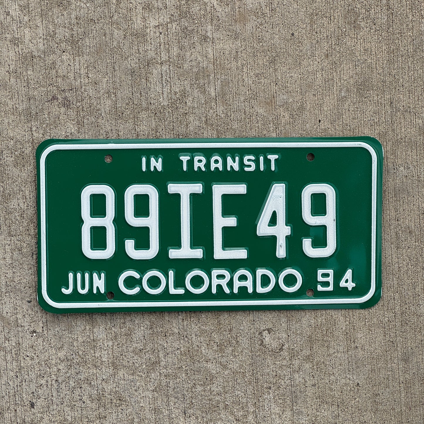 Photo of a 1994 Colorado In Transit Dealer License Plate Auto Tag Garage Decor Vintage 89 IE 49 with original patina