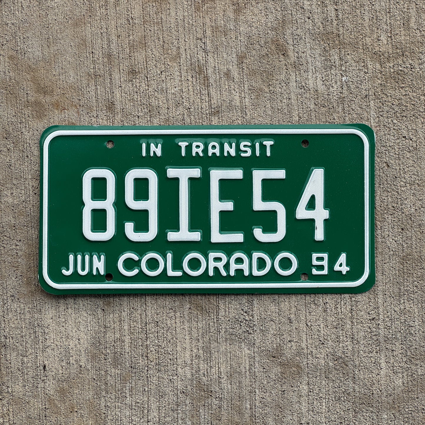 Photo of a 1994 Colorado In Transit Dealer License Plate Auto Tag Garage Decor Vintage 89 IE 54 with original patina