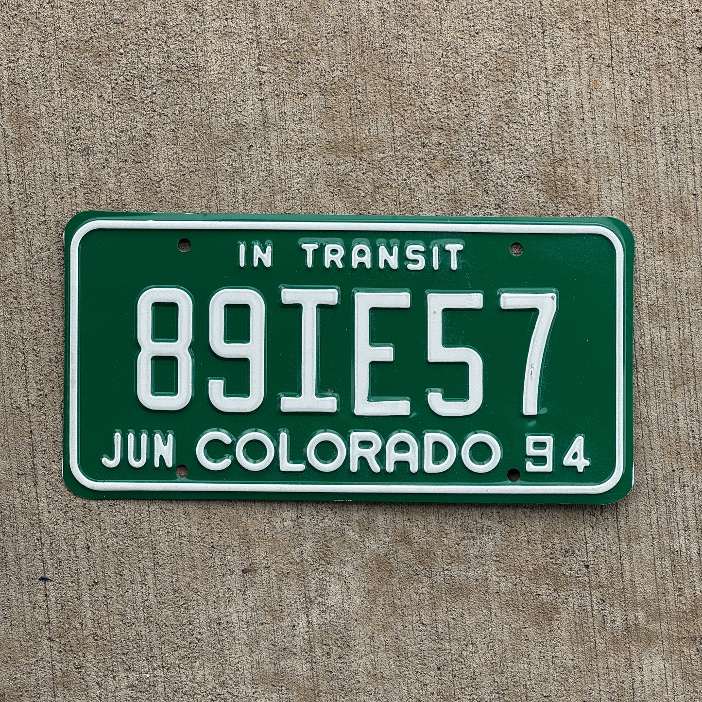 Photo of a 1994 Colorado In Transit Dealer License Plate Auto Tag Garage Decor Vintage 89 IE 57 with original patina