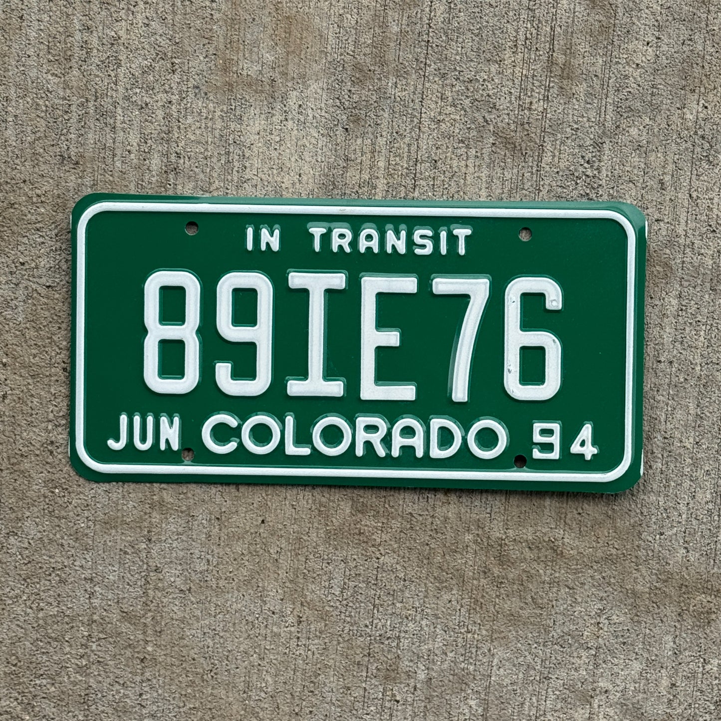 Photo of a 1994 Colorado In Transit Dealer License Plate Auto Tag Garage Decor Vintage 89 IE 76 with original patina