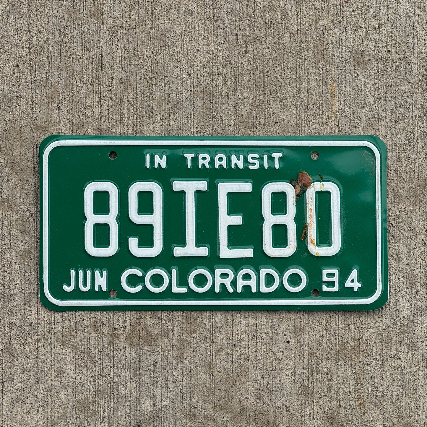 Photo of a 1994 Colorado In Transit Dealer License Plate Auto Tag Garage Decor Vintage 89 IE 80 with original patina