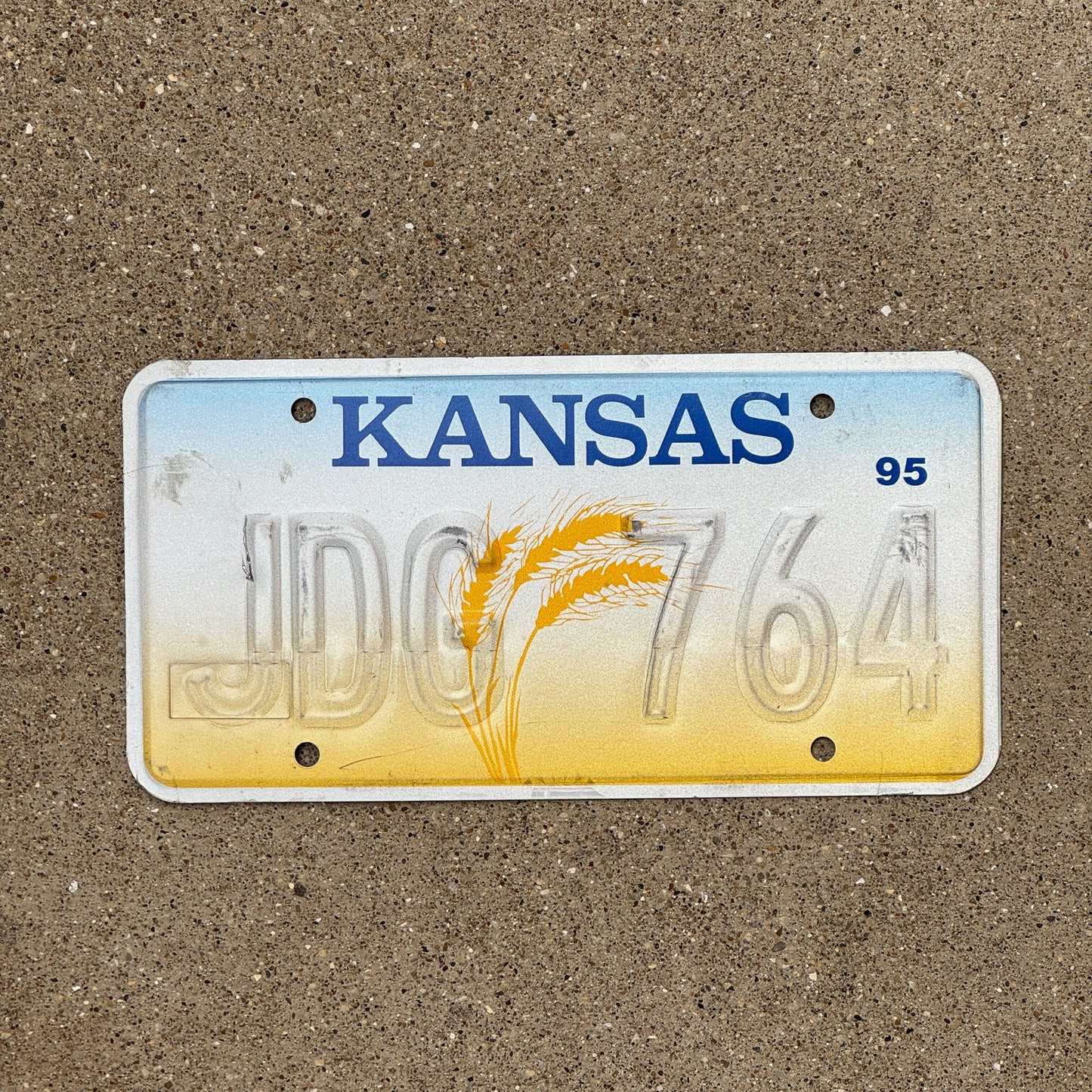 Photo of a 1995 Kansas Error License Plate Auto Tag Garage Decor Vintage Misprint Restamp JDG 764