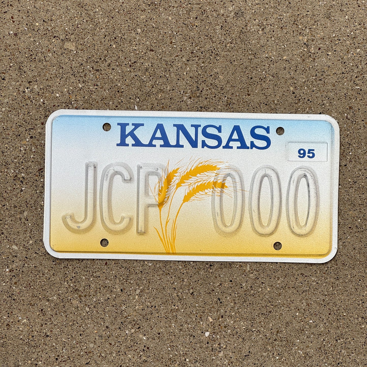 Photo of a 1995 Kansas Error License Plate Auto Tag Garage Decor Vintage Repeat Repeating Misprint JCP 000