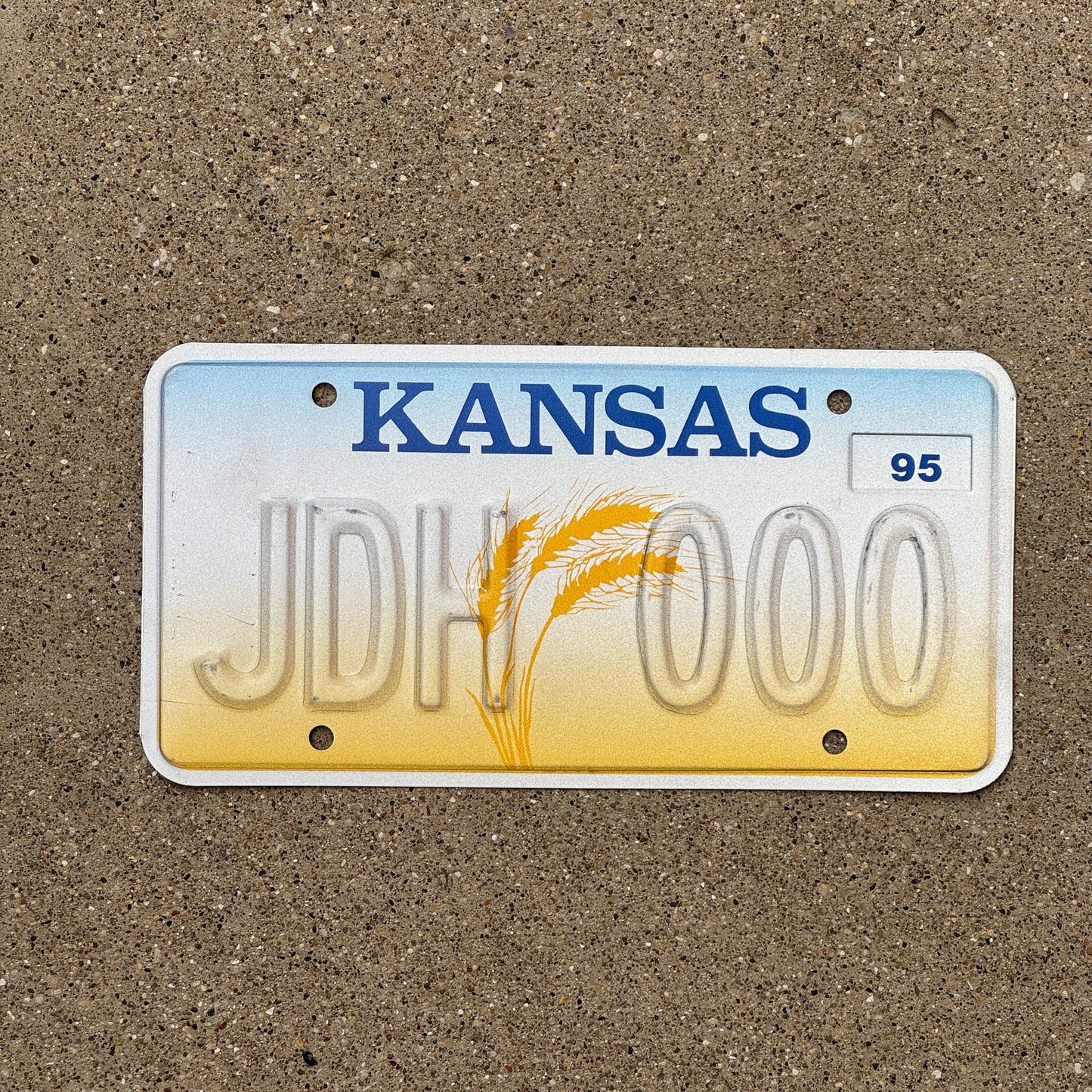 Photo of a 1995 Kansas Error License Plate Auto Tag Garage Decor Vintage Repeat Repeating Misprint JDH 000