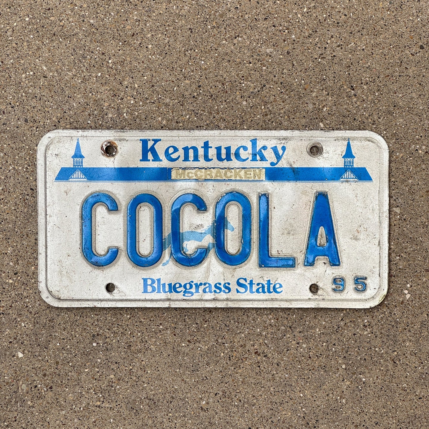 Photo of a 1995 Kentucky Vanity License Plate Auto Tag Garage Decor Vintage Coke Cola COCOLA