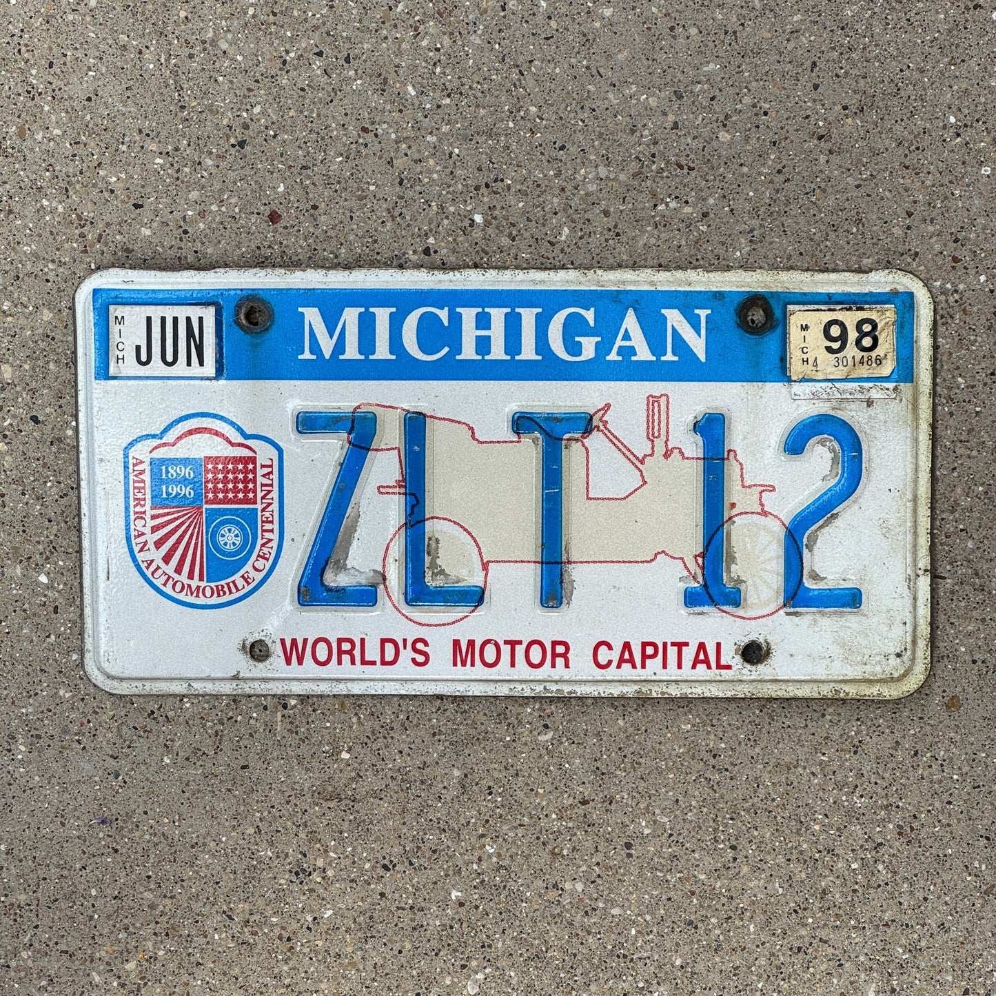 Photo of a 1996 1998 Michigan Graphic / Specialty License Plate Auto Tag Garage Decor Vintage World's Motor Capital ZLT 12