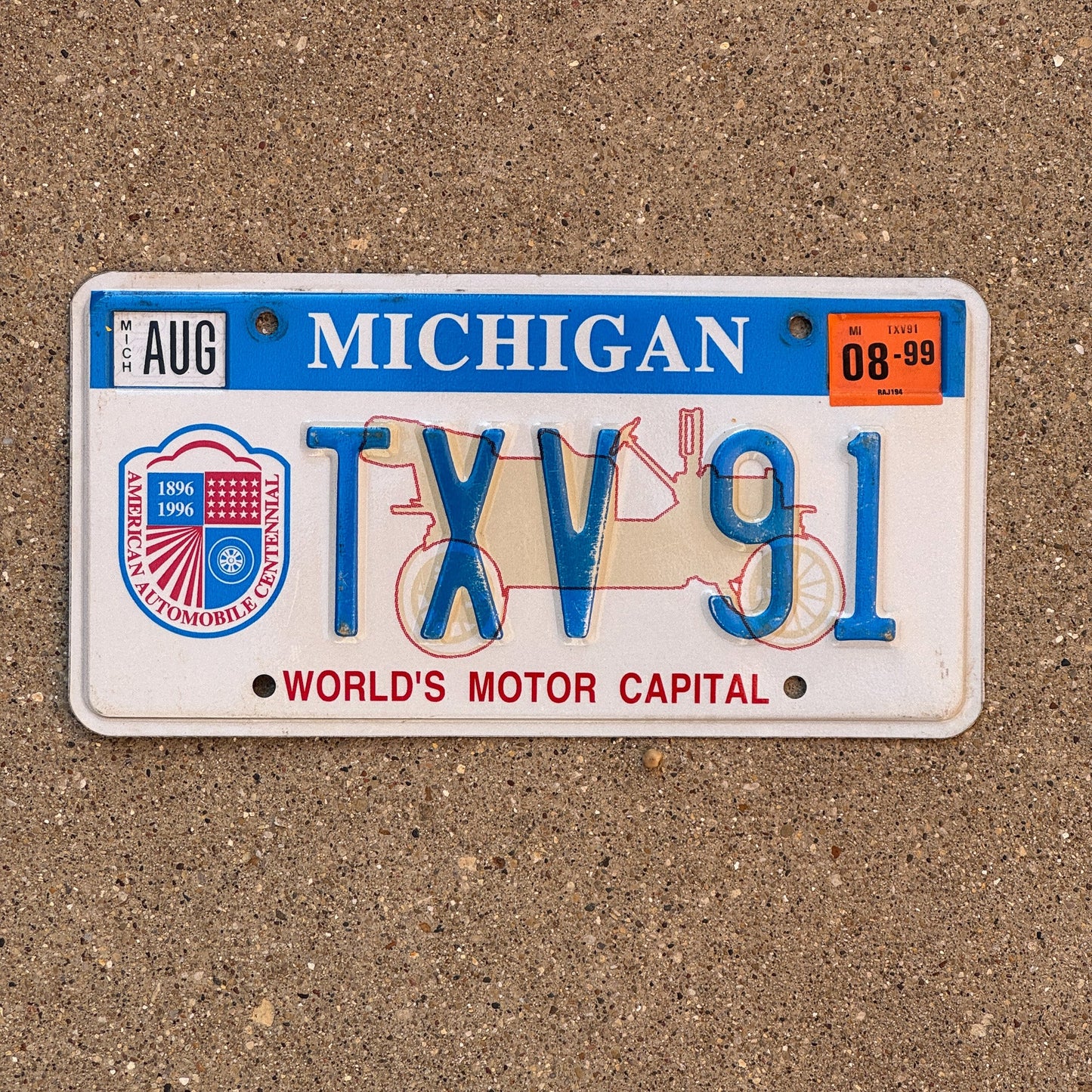 Photo of a 1996 1999 Michigan Graphic / Specialty License Plate Auto Tag Garage Decor Vintage World's Motor Capital TVX 91