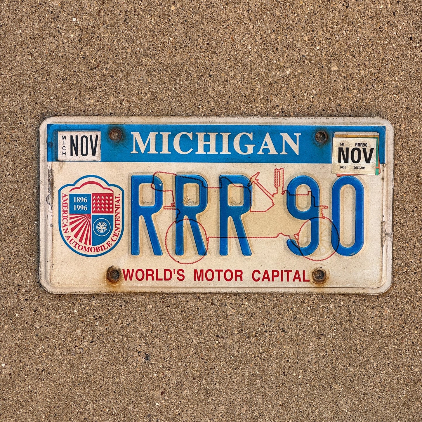 Photo of a 1996 2001 Michigan Graphic / Specialty License Plate Auto Tag Garage Decor Vintage World's Motor Capital RRR 90