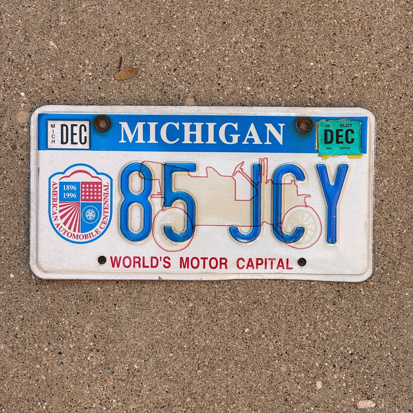 Photo of a 1996 2004 Michigan Graphic / Specialty License Plate Auto Tag Garage Decor Vintage World's Motor Capital 85 JCY