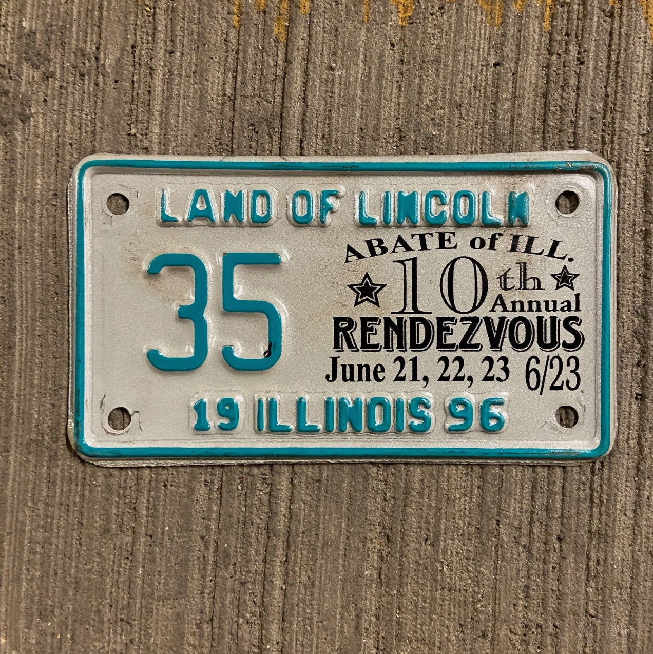 Photo of a 1996 Illinois Event Motorcycle License Plate Auto Tag Garage Decor Vintage ABATE 10th Rendezvous 35 35 with original patina