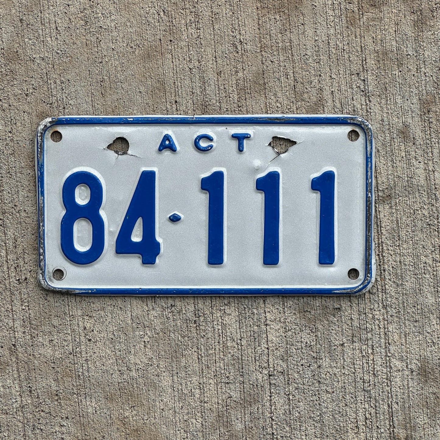 Photo of a 1997 Australian Capital Territory ACT Motorcycle License Plate Auto Tag Garage Decor Vintage Australia Repeat Repeating 84 111 with original patina