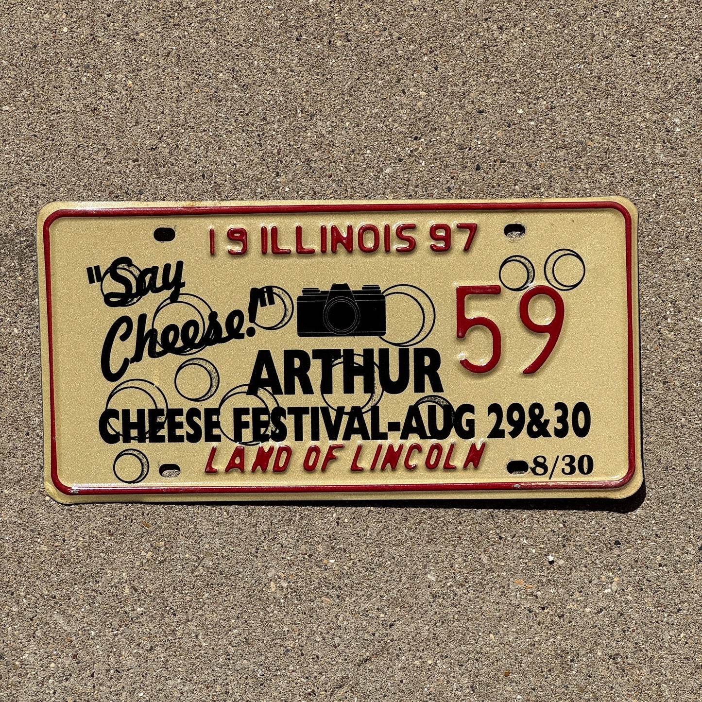 Photo of a 1997 Illinois EVENT License Plate Auto Tag 2 Garage Decor Vintage Say Cheese Festival Camera Arthur 59