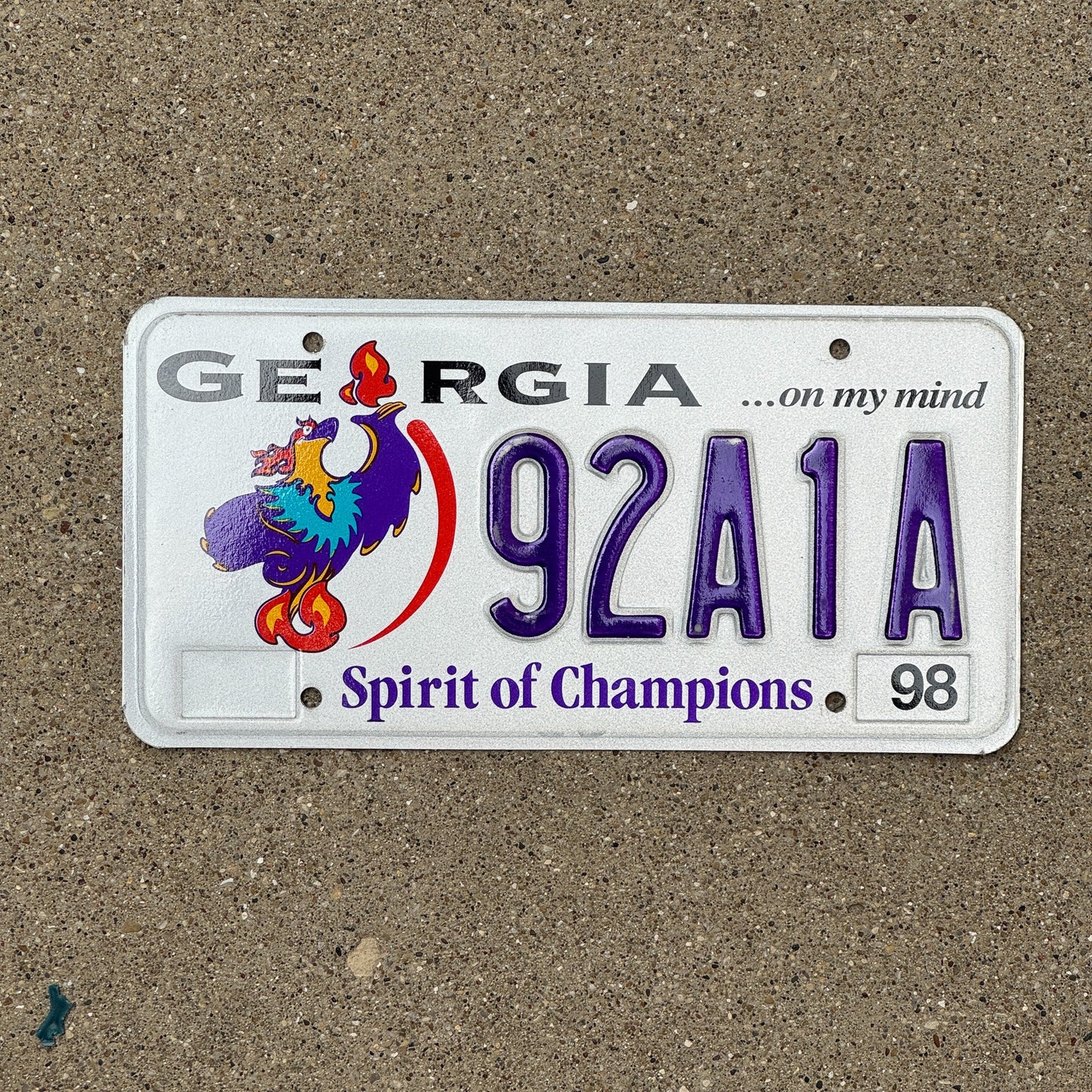 Photo of a 1998 Georgia Graphic / Specialty License Plate Auto Tag Garage Decor Vintage Spirit of Champtions Olympics 92 A1A