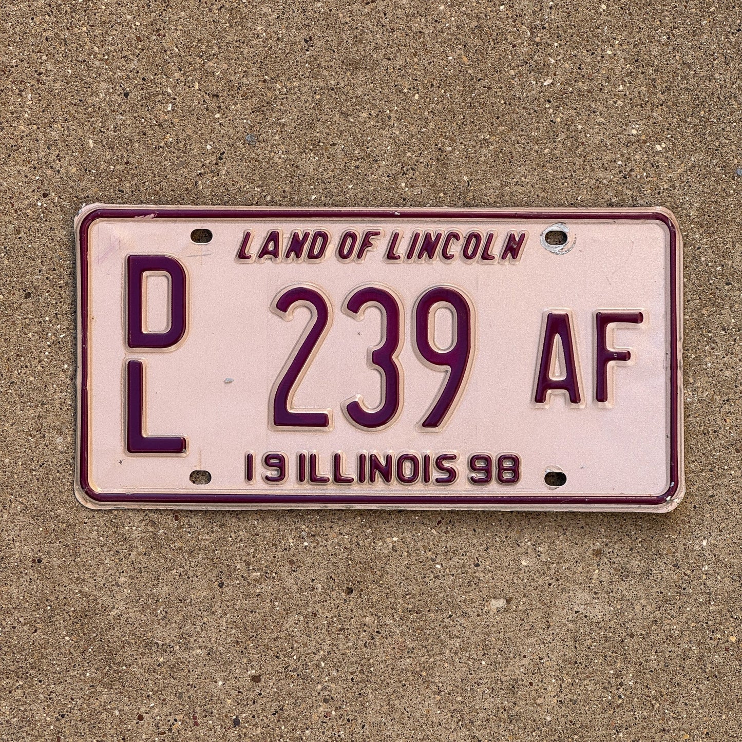 Photo of a 1998 Illinois Dealer License Plate Auto Tag Garage Decor Vintage Pink DL 239 AF