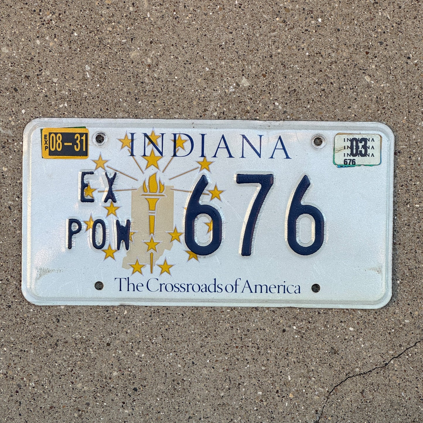 Photo of a 1999 2003 Indiana Ex Prisoner of War License Plate Auto Tag Garage Decor Vintage POW 676 with original patina