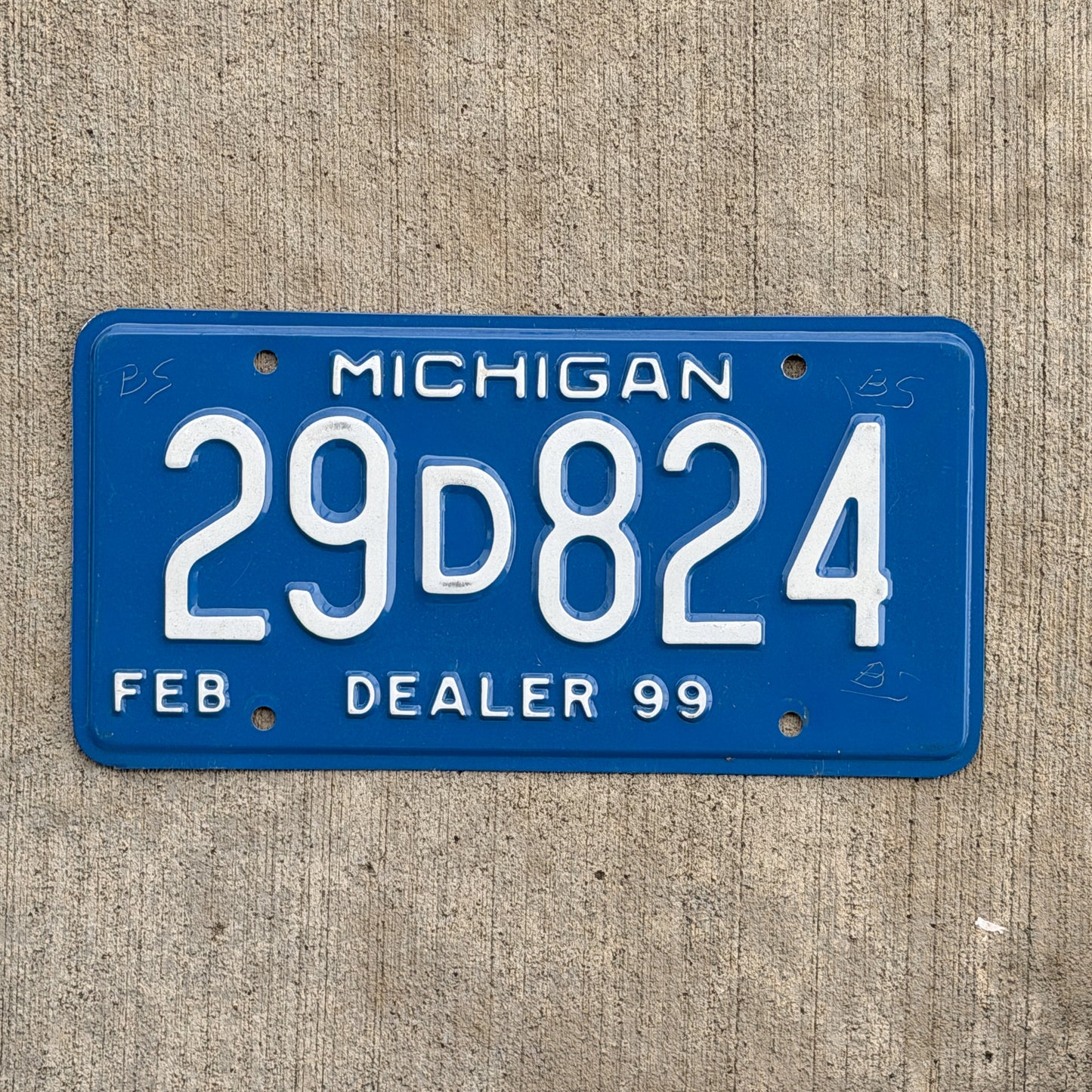 Photo of a 1999 Michigan Dealer License Plate Auto Tag Garage Decor Vintage 29 D 824 with original patina