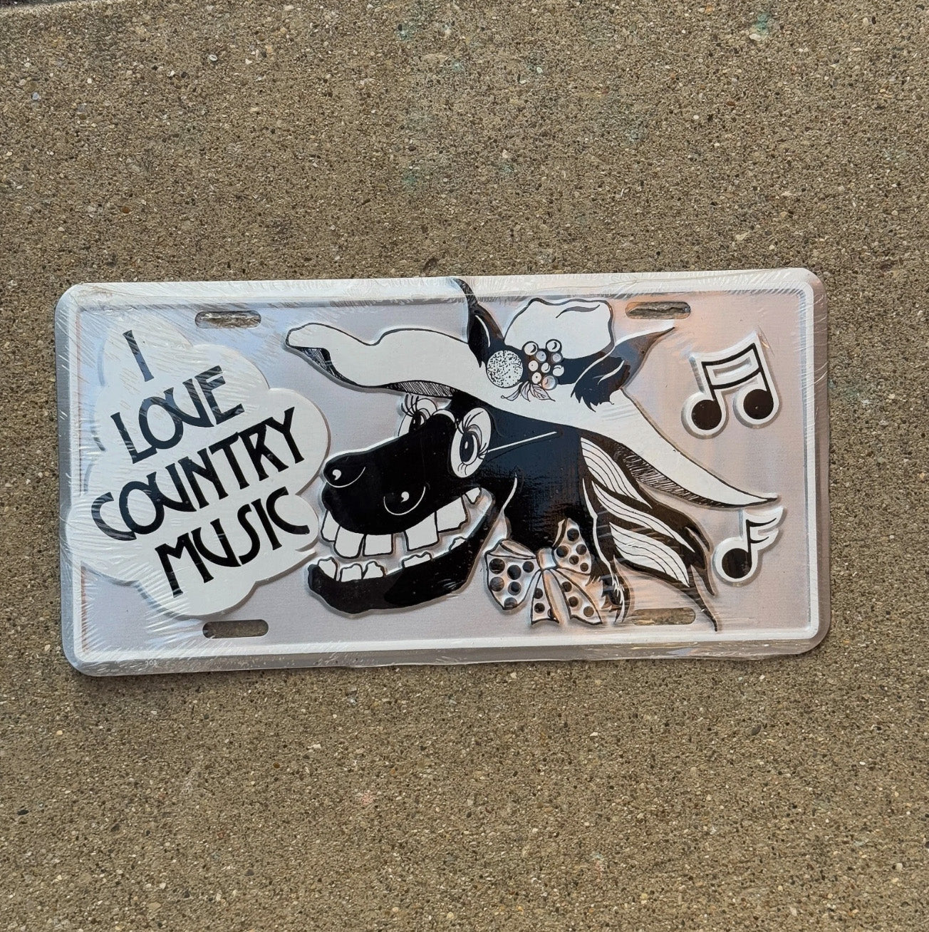 Photo of a 2000 Era Booster License Plate Auto Tag Garage Decor Vintage Country Music Horse Farm Country Music