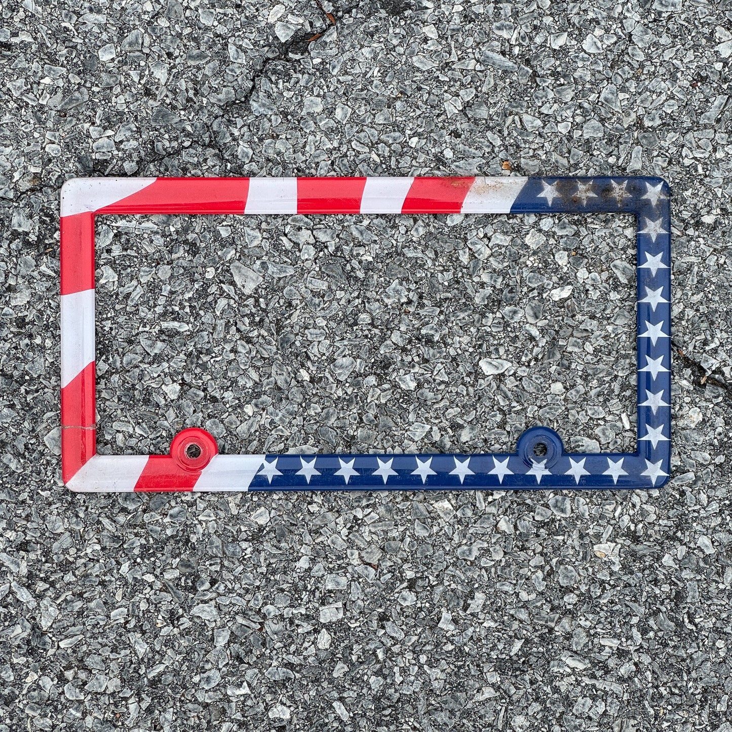 Photo of a 2000 Era License Plate Frame Auto Tag Garage Decor Vintage Plastic USA American Flag