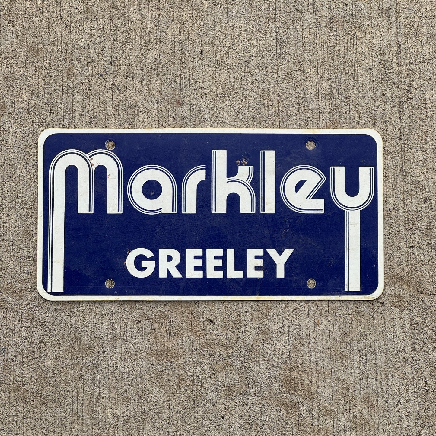 Photo of a 2000 Era Markley Greely Colorado Booster License Plate Auto Tag Garage Decor Vintage Flimsy Plastic with original patina