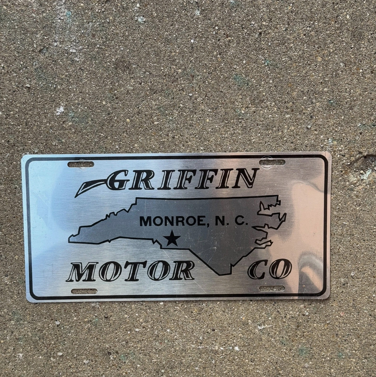 Photo of a 2000 Era North Carolina Booster License Plate Auto Tag Garage Decor Vintage Montroe NC Griffin Motor Co
