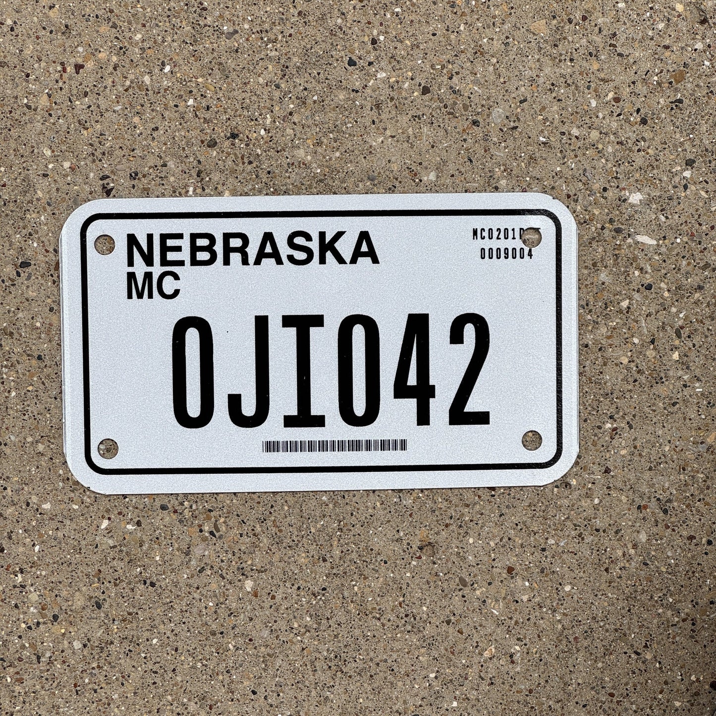 Photo of a 2002 Nebraska Motorcycle License Plate Auto Tag Garage Decor Vintage 0JI 042