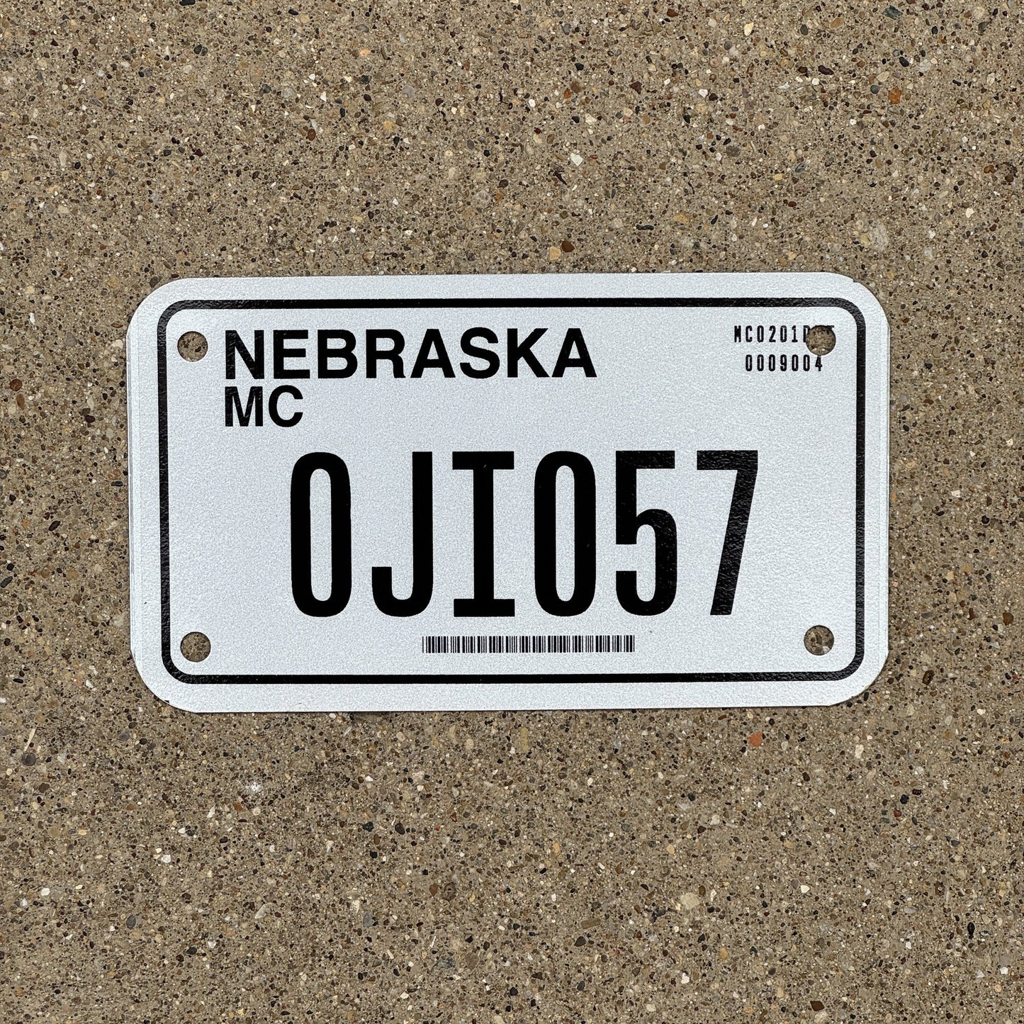 Photo of a 2002 Nebraska Motorcycle License Plate Auto Tag Garage Decor Vintage 0JI 057