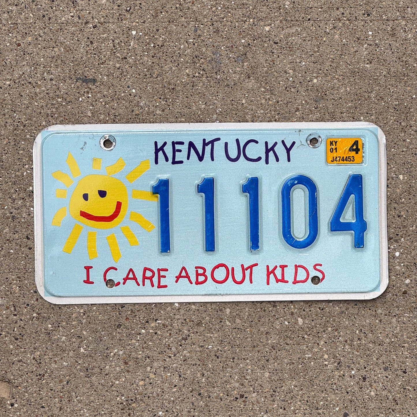 Photo of a 2003 Kentucky Graphic / Specialty License Plate Auto Tag Garage Decor Vintage I Care About Kids Childrens Trust Fund 11104