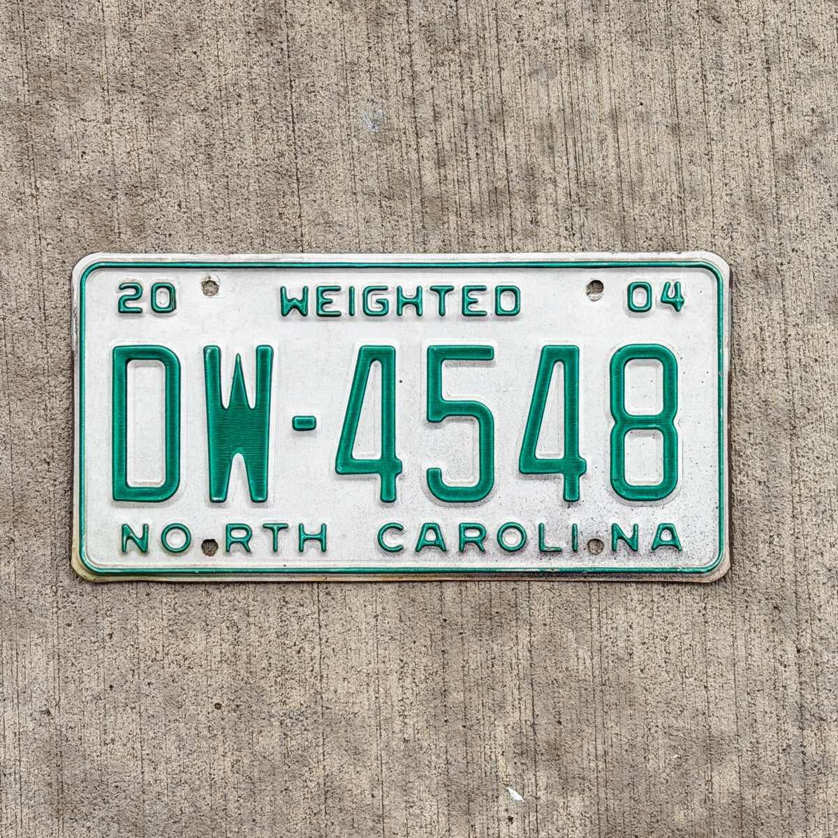 Photo of a 2004 North Carolina Commercial License Plate Auto Tag Garage Decor Vintage DW 4548 with original patina