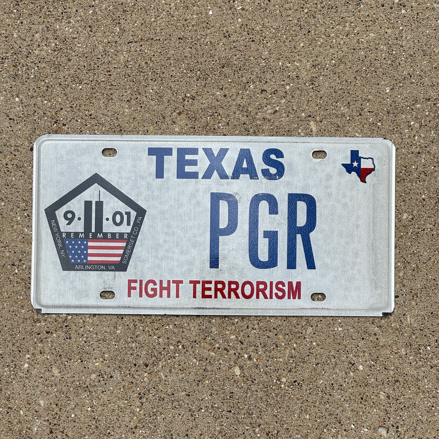 Photo of a 2004 Texas Graphic / Specialty License Plate Auto Tag Garage Decor Vintage Vanity Fight Terrorism 9/11 PGR