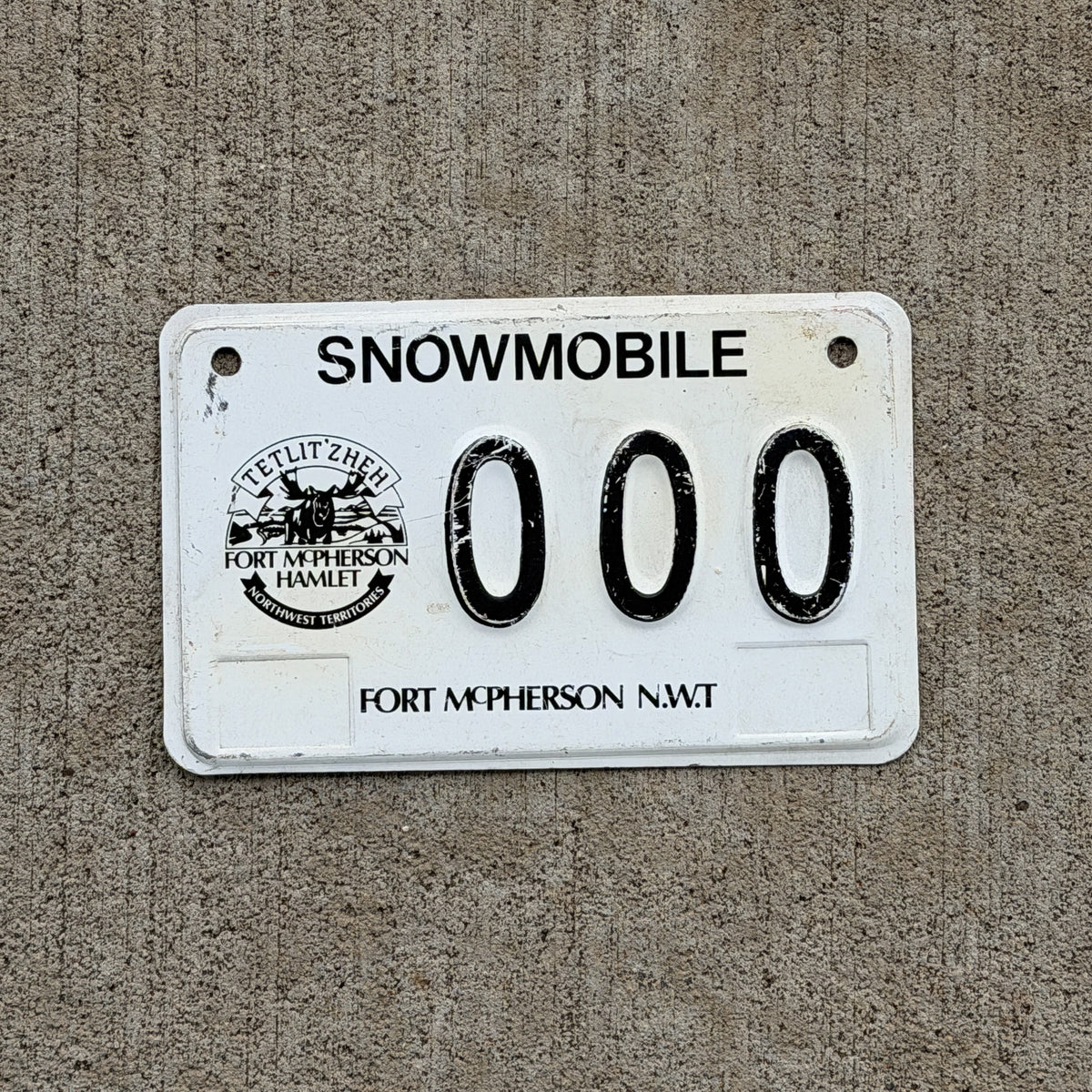 Photo of a 2006 Northwest Territories Snowmobile Sample License Plate Auto Fort McPherson Moose 000 with original patina