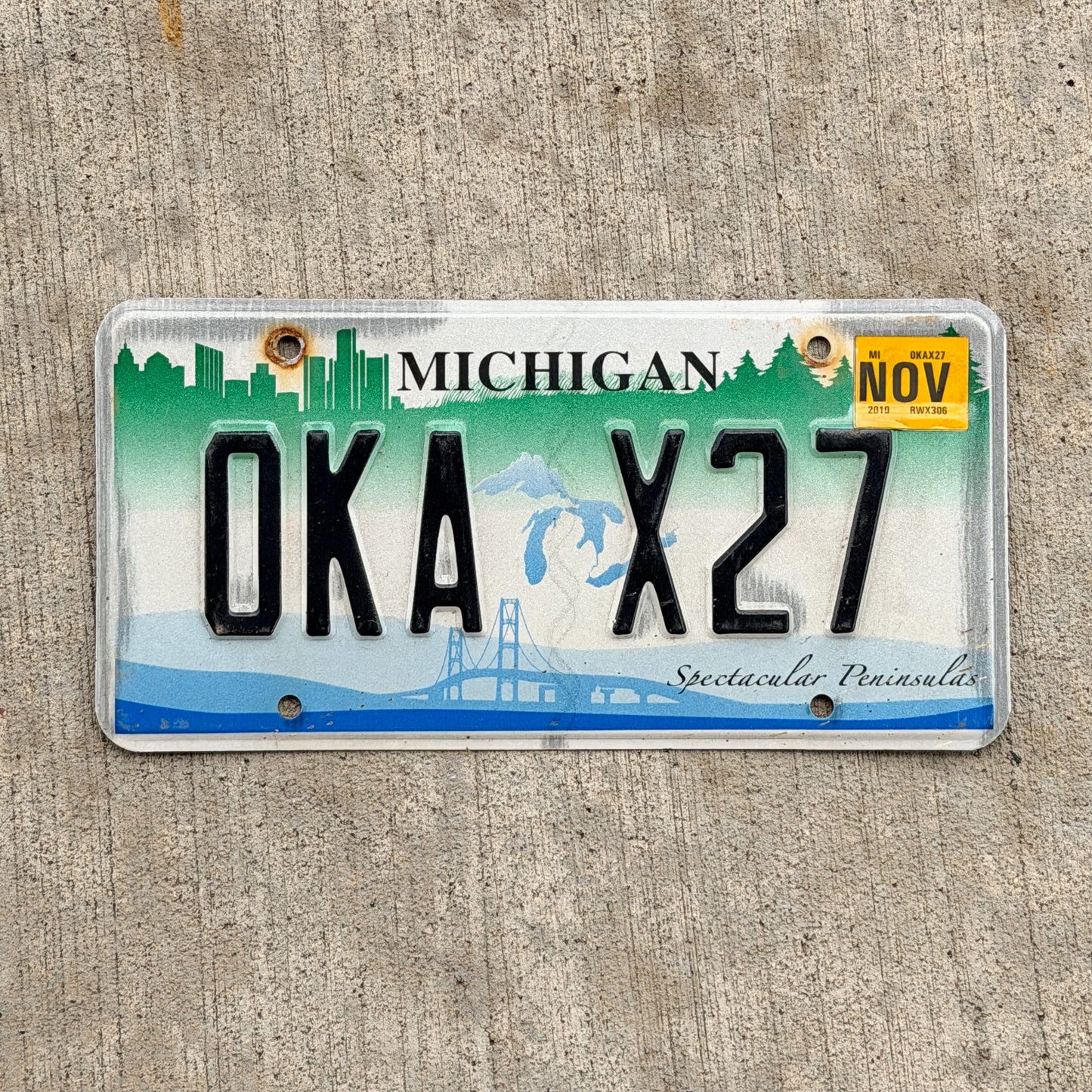 Photo of a 2007 2019 Michigan Graphic / Specialty License Plate Auto Tag Garage Decor Vintage Spectacular Peninsulas OKA X27 with original patina