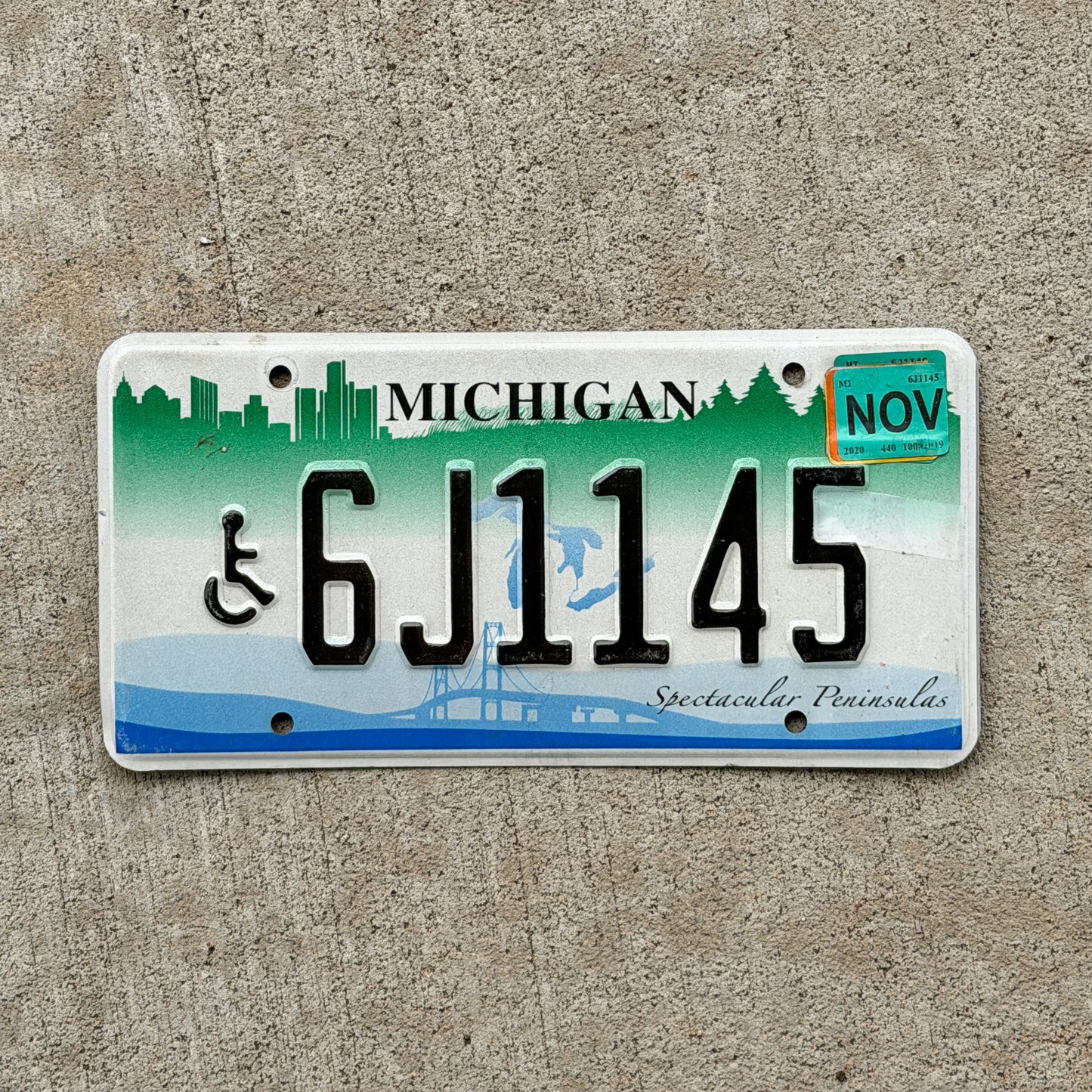 Photo of a 2007 2020 Michigan Graphic / Specialty License Plate Auto Tag Garage Decor Vintage Spectacular Peninsulas Handicap 6J1145 with original patina