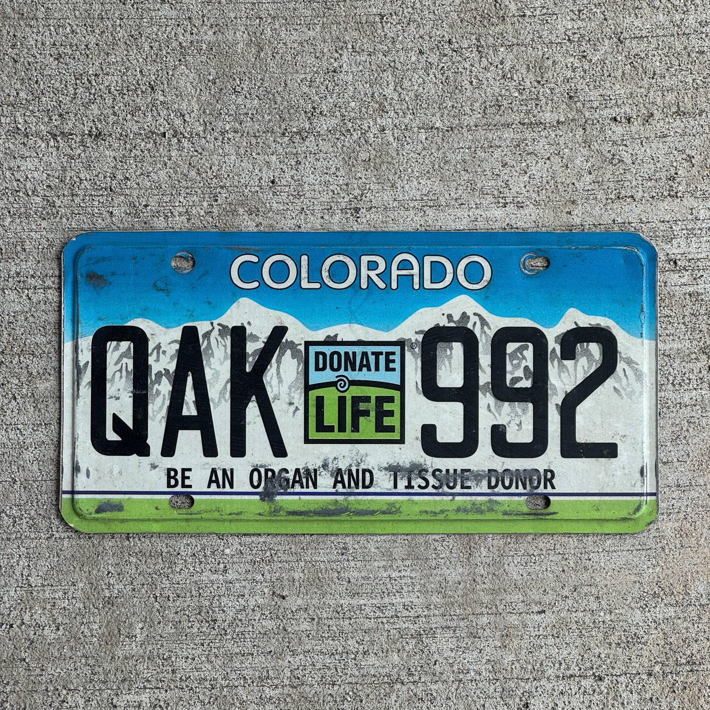 Photo of a 2009 Colorado Graphic / Specialty License Plate Auto Tag Garage Decor Vintage Donate Life Organ Donor QAK 992 with original patina