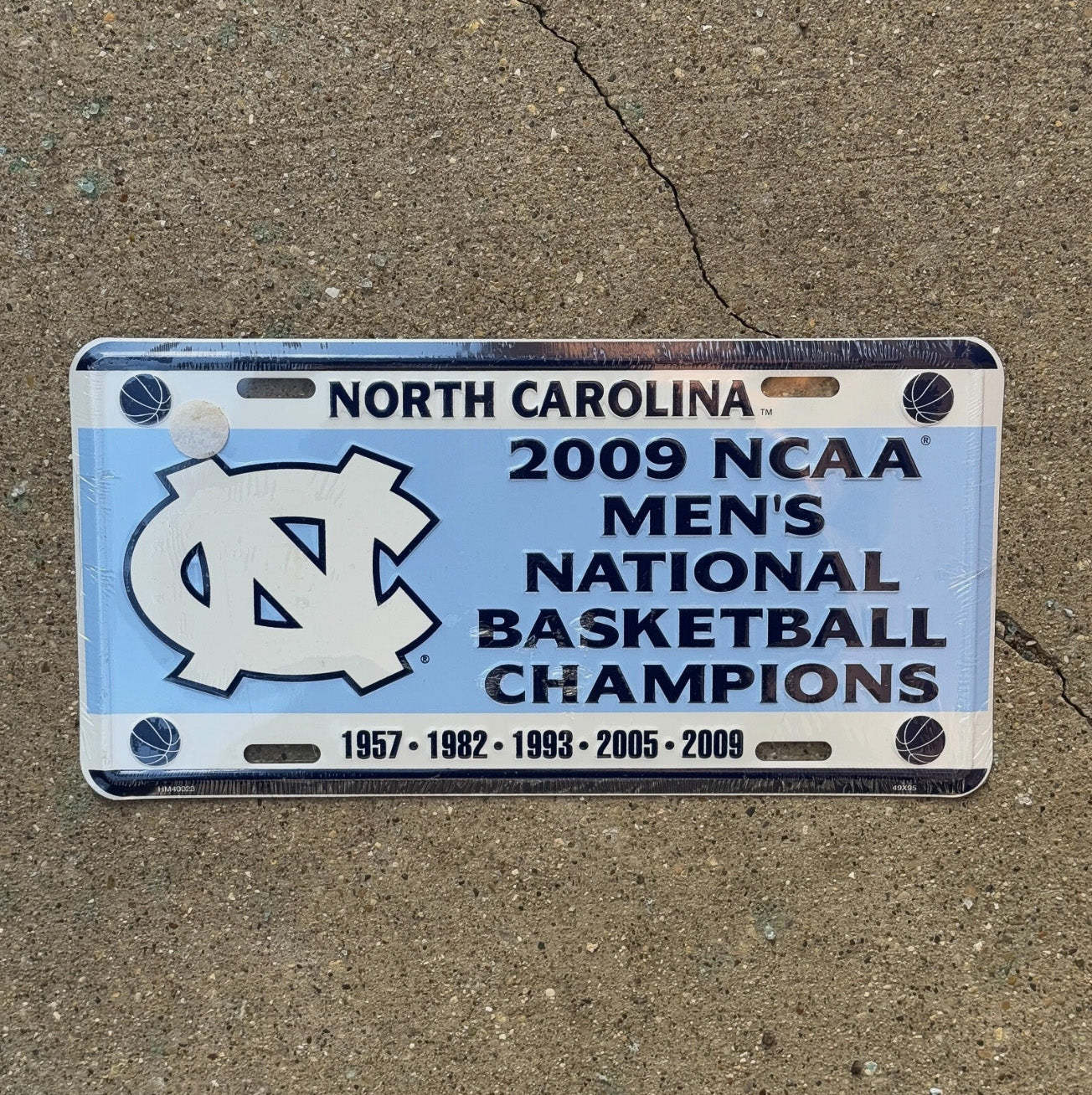 Photo of a 2009 North Carolina Booster License Plate Auto Tag Garage Decor Vintage UNC Basketball NCAA Champs