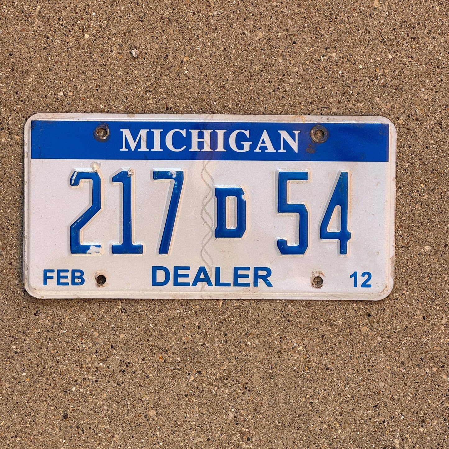 Photo of a 2012 Michigan Dealer License Plate Auto Tag Garage Decor Vintage 217 D 54