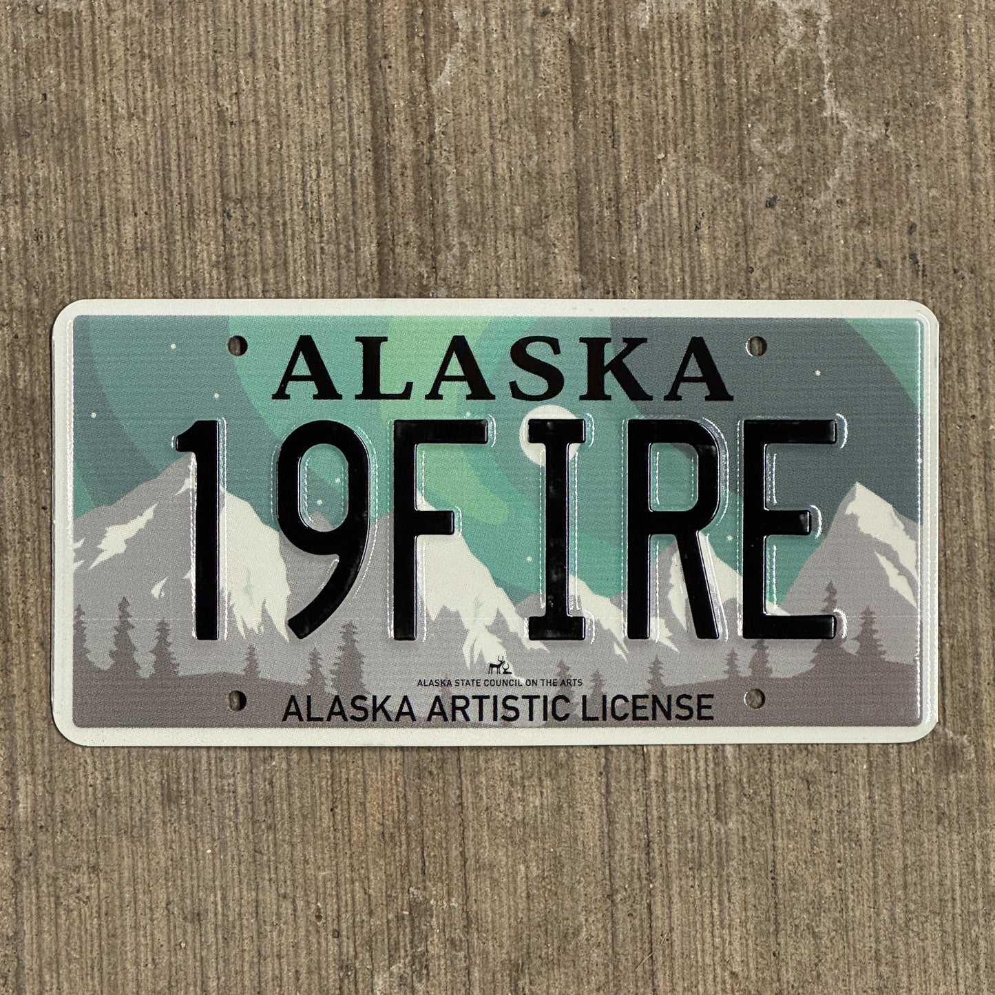 Photo of a 2019 Alaska Graphic Vanity License Plate Auto Tag 2 Vintage Garage Artistic Northern Lights Firefighter 19 FIRE with original patina