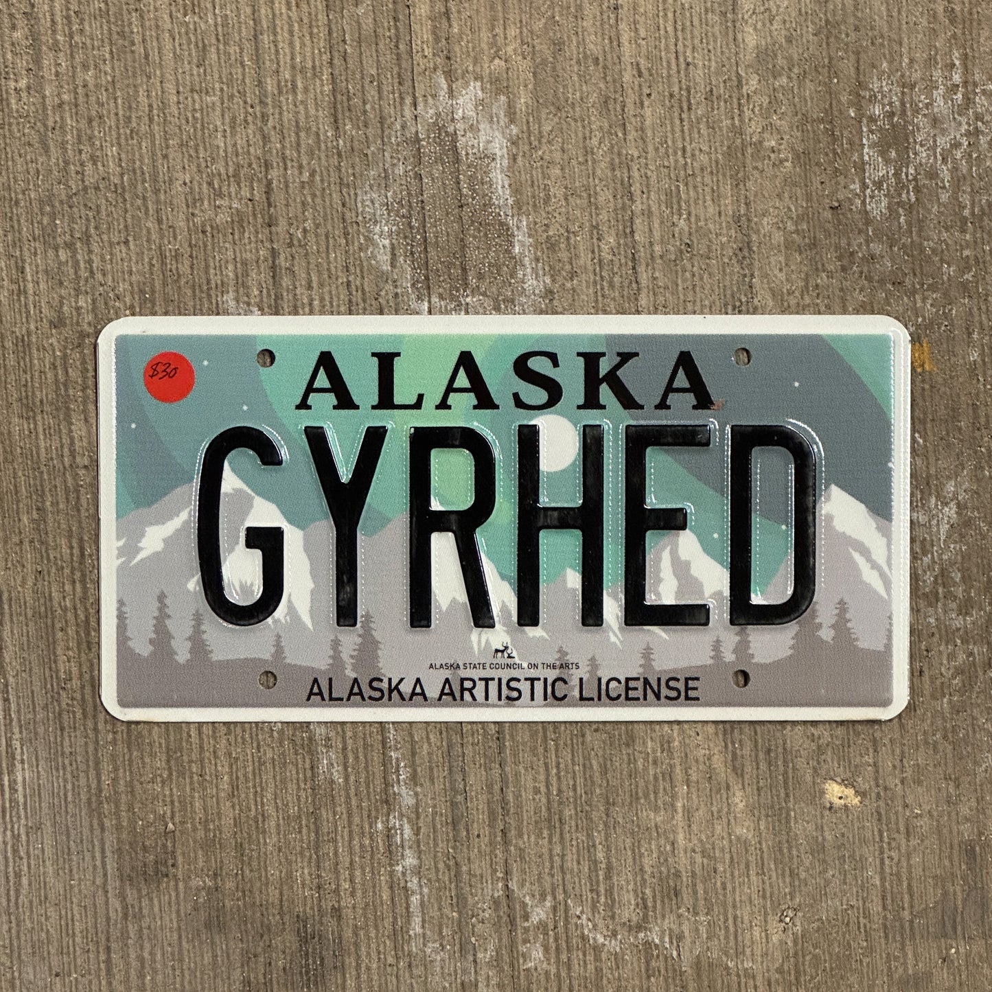 Photo of a 2019 Alaska Graphic Vanity License Plate Auto Tag 2 Vintage Garage Artistic Northern Lights Gear Head GYRHED with original patina