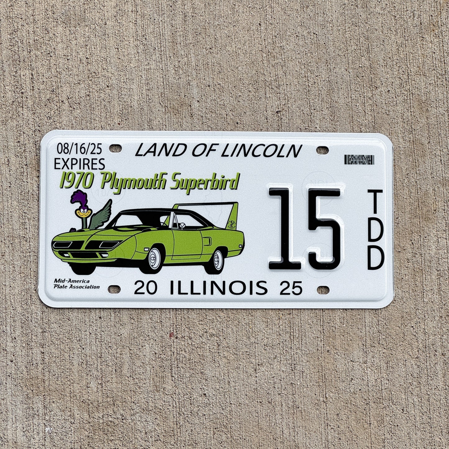 Photo of a 2025 Illinois Event License Plate Auto Tag 2 Vintage Garage Plymouth Superbird Two Digit 15 with original patina