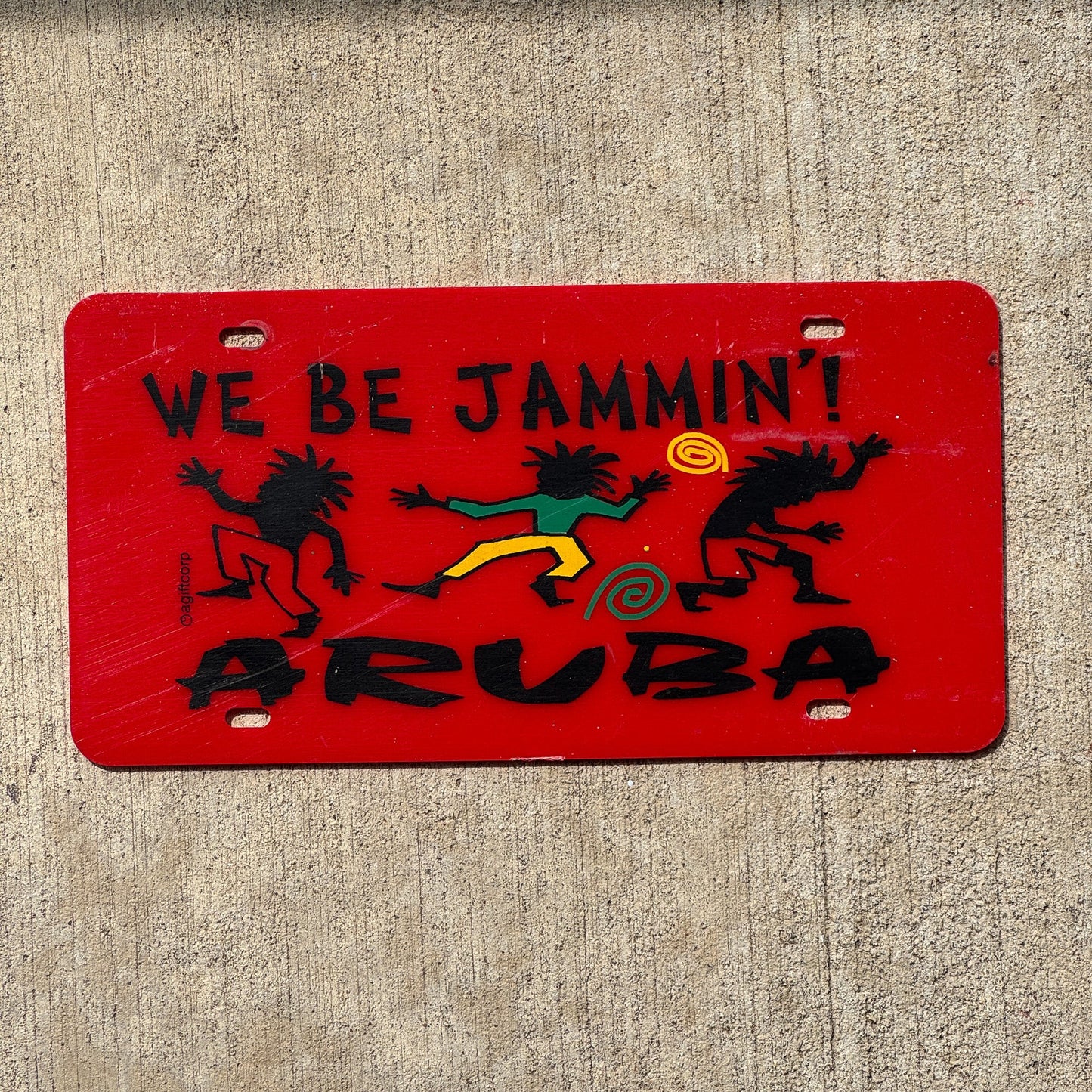 Photo of a Aruba Booster License Plate Auto Tag Garage Decor Vintage Plastic We Be Jammin