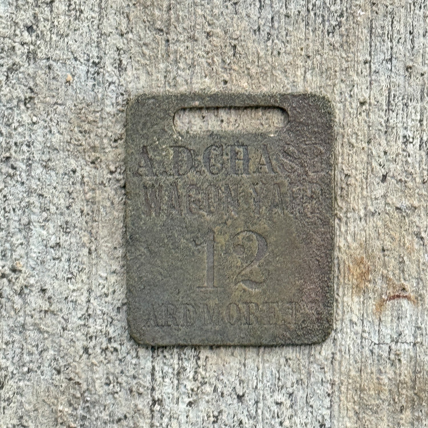 Photo of a 1900 Era A.D. Chase Wagon Yard Ardmore Oklahoma Auto Tag Garage Decor Vintage Tag Fob with original patina