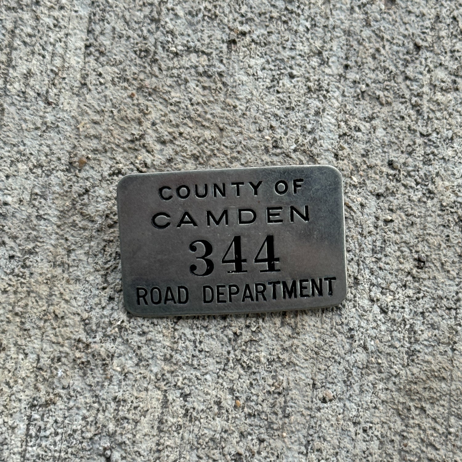 Photo of a 1900 Era County of Camden Road Department New Jersey Auto Tag Garage Decor Vintage Pin 344 with original patina