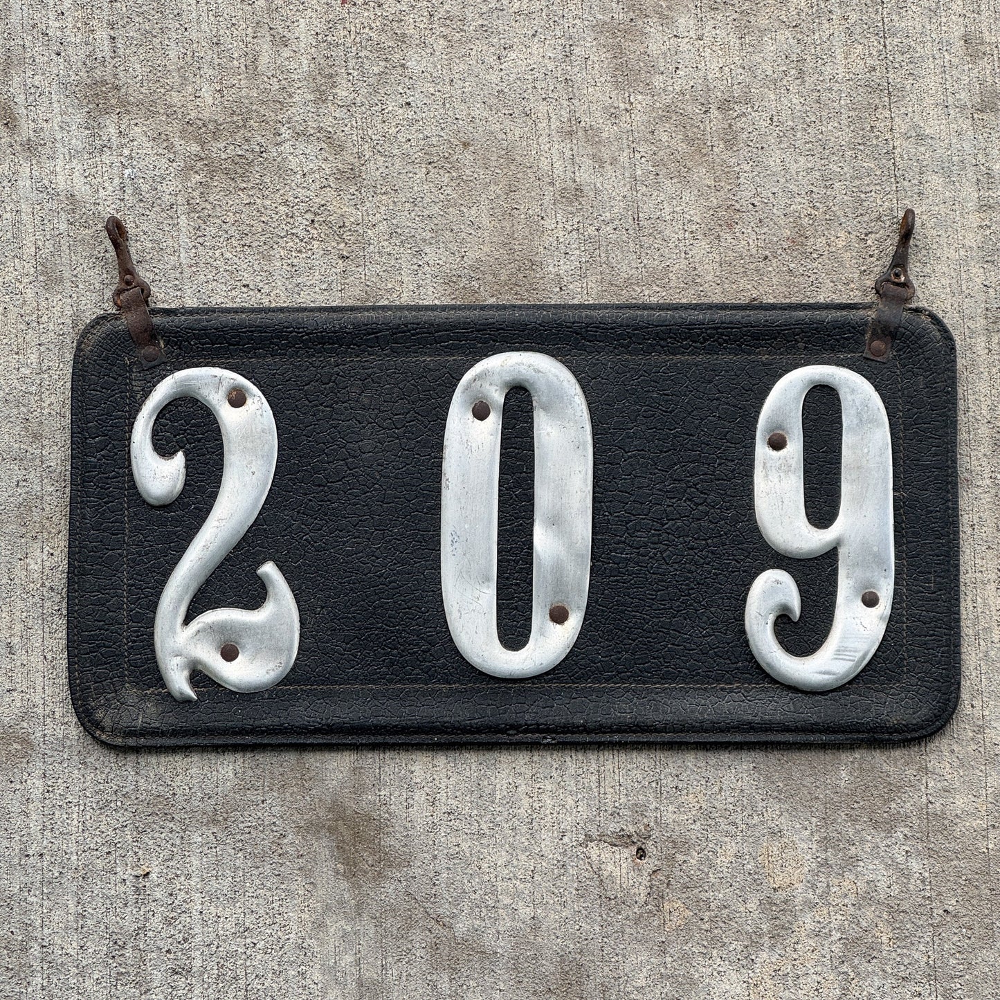 Photo of a 1907 1917 Texas Leather Prestate License Plate Auto Tag Garage Decor Vintage Low Number Three Digit 209 with original patina