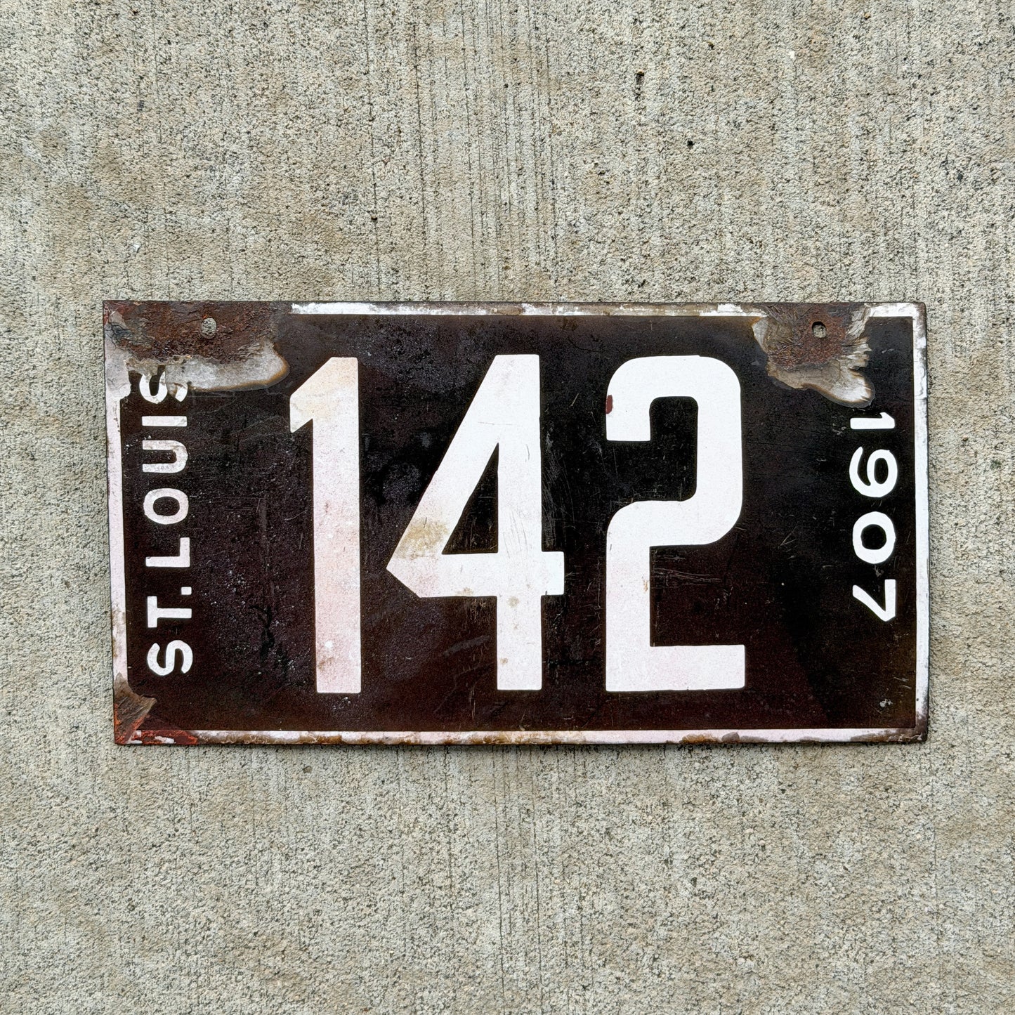 Photo of a 1907 Missouri Porcelain License Plate Auto Tag Garage Low Number Three Digit 142 with original patina