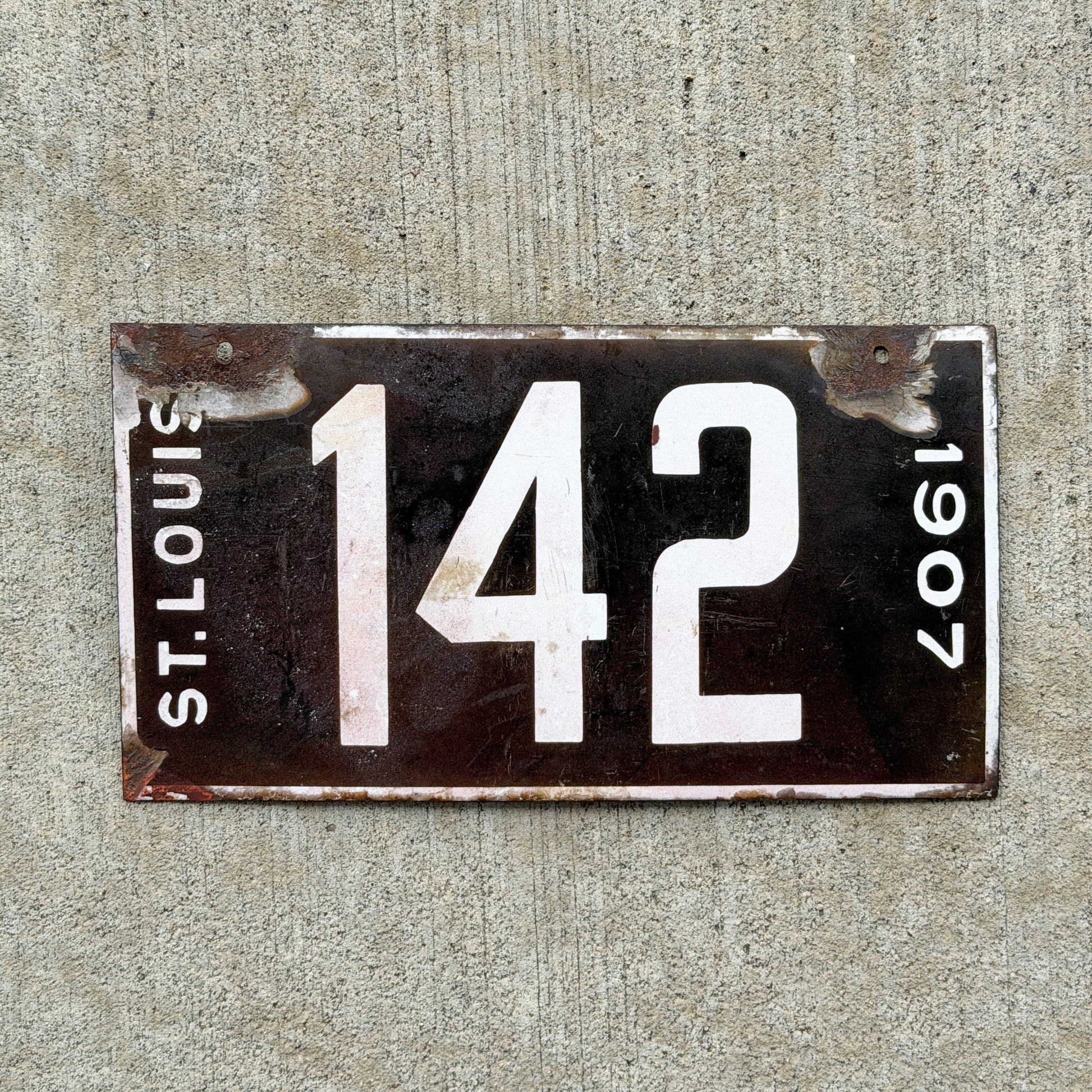 Photo of a 1907 Missouri Porcelain License Plate Auto Tag Garage Low Number Three Digit 142 with original patina