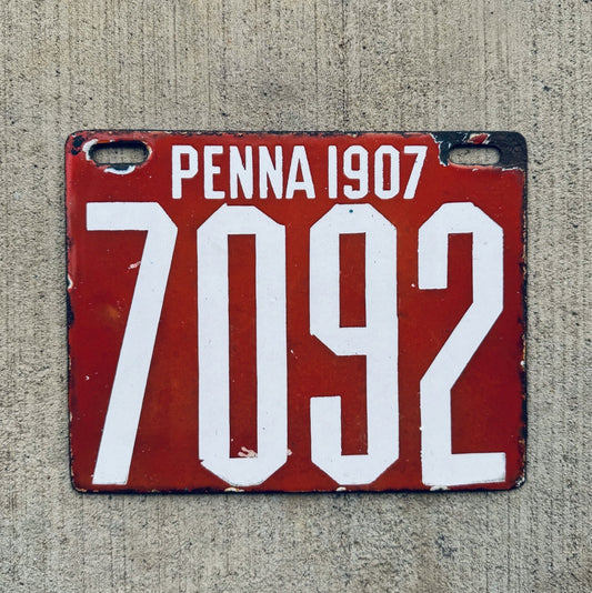 Photo of a 1907 Pennsylvania Porcelain License Plate Auto Tag Garage Decor Vintage Low Number Four Digit 7092 with original patina